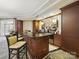 Updated kitchenette features dark cabinetry, modern appliances, and bar stool seating at 300 W 5Th St # 339, Charlotte, NC 28202