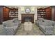 Cozy library featuring a fireplace, shelving, and comfortable seating at 300 W 5Th St # 339, Charlotte, NC 28202