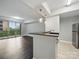 Open living space with dark wood floors, a breakfast bar, and a sliding glass door leading to a balcony at 300 W 5Th St # 339, Charlotte, NC 28202