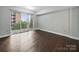 Living room with wood floors featuring a balcony with black metal railings at 300 W 5Th St # 339, Charlotte, NC 28202