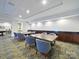 Well-lit meeting room featuring wood tables, padded chairs, and storage cabinetry at 300 W 5Th St # 339, Charlotte, NC 28202