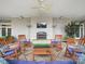 Inviting covered patio with fireplace, ceiling fan, outdoor heaters and rocking chairs with blue cushions at 300 W 5Th St # 339, Charlotte, NC 28202