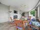 Relaxing covered patio features a fireplace, ceiling fan, outdoor heaters, and wooden furniture with blue cushions at 300 W 5Th St # 339, Charlotte, NC 28202