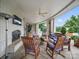 Covered patio with fireplace, ceiling fan, outdoor heaters and wood furniture with blue cushions at 300 W 5Th St # 339, Charlotte, NC 28202