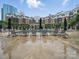 Luxury apartment complex has outdoor pool surrounded by mature trees and lounge chairs at 300 W 5Th St # 339, Charlotte, NC 28202