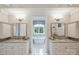 This bathroom features dual sinks, a granite countertop, and a stand-alone tub at 3032 Kings Manor Dr, Matthews, NC 28104