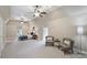 Spacious bedroom showcasing neutral walls, ceiling fans and a sitting area with cozy chairs at 3032 Kings Manor Dr, Matthews, NC 28104