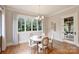 Cozy dining room with large windows, hardwood floors, and an elegant chandelier at 3032 Kings Manor Dr, Matthews, NC 28104