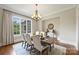 Elegant dining room with a large window, chandelier, and stylish furnishings at 3032 Kings Manor Dr, Matthews, NC 28104