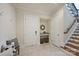 This foyer features a bench, built-in storage, tiled floor, and a staircase with iron railings at 3032 Kings Manor Dr, Matthews, NC 28104