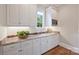 Butler's pantry featuring granite countertops, white cabinets, and stainless steel appliances at 3032 Kings Manor Dr, Matthews, NC 28104