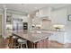 Gourmet kitchen features white cabinetry, stainless steel appliances, and a center island with bar stools at 3032 Kings Manor Dr, Matthews, NC 28104
