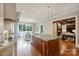 Bright kitchen with granite countertops, stainless appliances, an eat-in area, and a view to the living room at 3032 Kings Manor Dr, Matthews, NC 28104