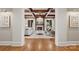 Open view of the living room with coffered ceilings and a stone fireplace, from the hallway at 3032 Kings Manor Dr, Matthews, NC 28104