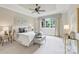 Serene bedroom featuring a tray ceiling, large windows, and plush decor for a relaxing retreat at 3032 Kings Manor Dr, Matthews, NC 28104