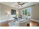Sunny office area featuring hardwood floors, a ceiling fan, and sophisticated decor at 3032 Kings Manor Dr, Matthews, NC 28104