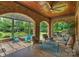 Elegant outdoor seating area features brick archways and a wood ceiling with fan at 3032 Kings Manor Dr, Matthews, NC 28104
