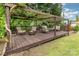 Outdoor backyard deck featuring a cozy seating area with a fire pit, surrounded by a green lawn at 309 Ogden Dr, Gastonia, NC 28056