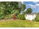Green backyard includes play set and shed, blending recreation and storage at 309 Ogden Dr, Gastonia, NC 28056