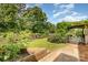 Expansive green backyard features a garden, pergola and deck that offer outdoor relaxation and recreation at 309 Ogden Dr, Gastonia, NC 28056