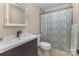 Bathroom with dark vanity and patterned shower curtain at 309 Ogden Dr, Gastonia, NC 28056