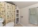 Cozy bathroom with patterned shower curtain, built in storage, and soft towels at 309 Ogden Dr, Gastonia, NC 28056