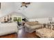 Cozy bonus room with a bed, sofa, desk, and natural light, providing a comfortable living space at 309 Ogden Dr, Gastonia, NC 28056