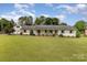 Charming one-story home with brick exterior, lush lawn, and a separate garage at 309 Ogden Dr, Gastonia, NC 28056