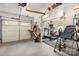 Bright and well-lit garage, now a home gym with an exercise bench and work space by garage doors at 309 Ogden Dr, Gastonia, NC 28056