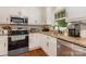 Well-appointed kitchen with modern stainless appliances and stone countertops at 309 Ogden Dr, Gastonia, NC 28056