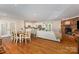 Open-concept living room showcasing the kitchen, dining area, fireplace, and hardwood floors at 309 Ogden Dr, Gastonia, NC 28056