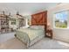 Large main bedroom with a decorative door behind the bed, a ceiling fan, and built-in bookshelves at 309 Ogden Dr, Gastonia, NC 28056