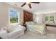 Spacious main bedroom featuring a decorative door behind the bed, and a seating nook at 309 Ogden Dr, Gastonia, NC 28056