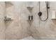 Elegant shower with tan tile surround and built-in shelving at 309 Ogden Dr, Gastonia, NC 28056