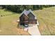 Overhead shot of modern home, highlighting its sleek design, large driveway, and lush surrounding greenery at 309 Sain Rd, Statesville, NC 28625