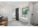 Elegant bathroom featuring a soaking tub, modern fixtures, and natural light, perfect for relaxation at 309 Sain Rd, Statesville, NC 28625