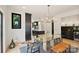 Modern dining area with a glass table, unique lighting, and open access to the kitchen at 309 Sain Rd, Statesville, NC 28625