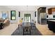 Bright dining room featuring glass table, grey rug, and view of the outdoors at 309 Sain Rd, Statesville, NC 28625