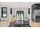 Bright dining room with hardwood floors, modern lighting, and views of the outdoor space at 309 Sain Rd, Statesville, NC 28625