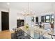 Spacious open-concept dining area with glass table adjacent to the living room and wet bar at 309 Sain Rd, Statesville, NC 28625