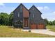 Contemporary two-story home features a two-car garage, modern siding and professional landscaping at 309 Sain Rd, Statesville, NC 28625