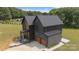 Aerial view of modern home showcases its unique roofline, attached garage, and well-manicured lawn at 309 Sain Rd, Statesville, NC 28625