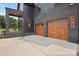 Modern home featuring a brick facade and two-car wooden garage at 309 Sain Rd, Statesville, NC 28625