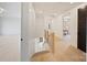 Bright hallway with hardwood floors, modern railing, and doors leading to other rooms in the home at 309 Sain Rd, Statesville, NC 28625