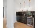 Stylish wet bar with black marble countertop, modern fixtures, wine fridge, and gold accents at 309 Sain Rd, Statesville, NC 28625