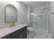 A beautifully renovated bathroom with a sleek vanity, quartz countertop, and glass enclosed shower at 3601 Woody Grove Ln, Charlotte, NC 28210