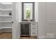 Neat butler's pantry with wine fridge, shelving, and marble countertop at 3601 Woody Grove Ln, Charlotte, NC 28210