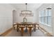 Dining room featuring a wooden table, white chairs, and natural light from a nearby window at 3601 Woody Grove Ln, Charlotte, NC 28210