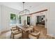 Open dining room, view to office space, featuring a wooden table, white chairs, and natural light at 3601 Woody Grove Ln, Charlotte, NC 28210