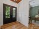 Inviting foyer with black double doors, hardwood floors, and views into office space at 3601 Woody Grove Ln, Charlotte, NC 28210